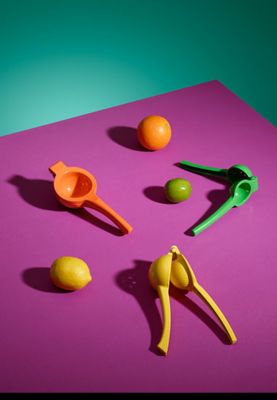 An orange squeezer, a lemon squeezer and a lime squeezer
