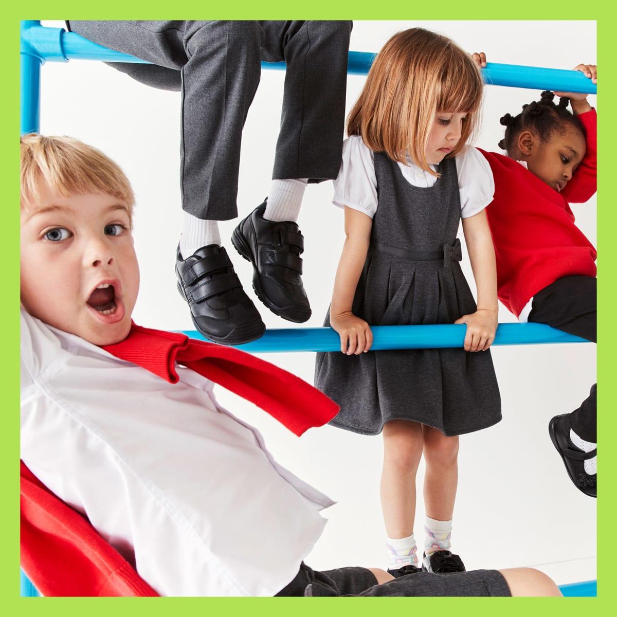 Several children wearing assorted styles of school uniform. Shop uniform