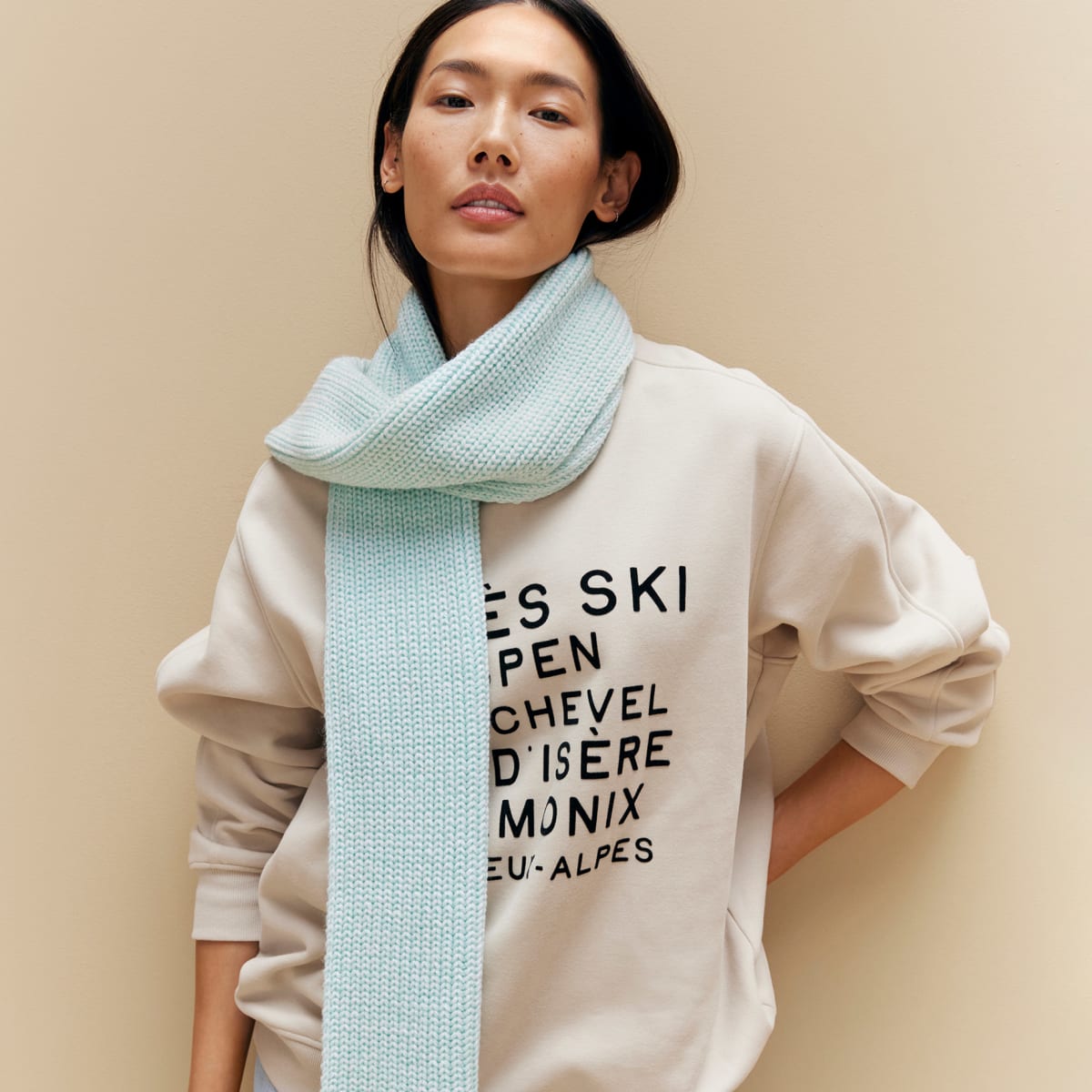  Woman wearing slogan sweatshirt and blue scarf