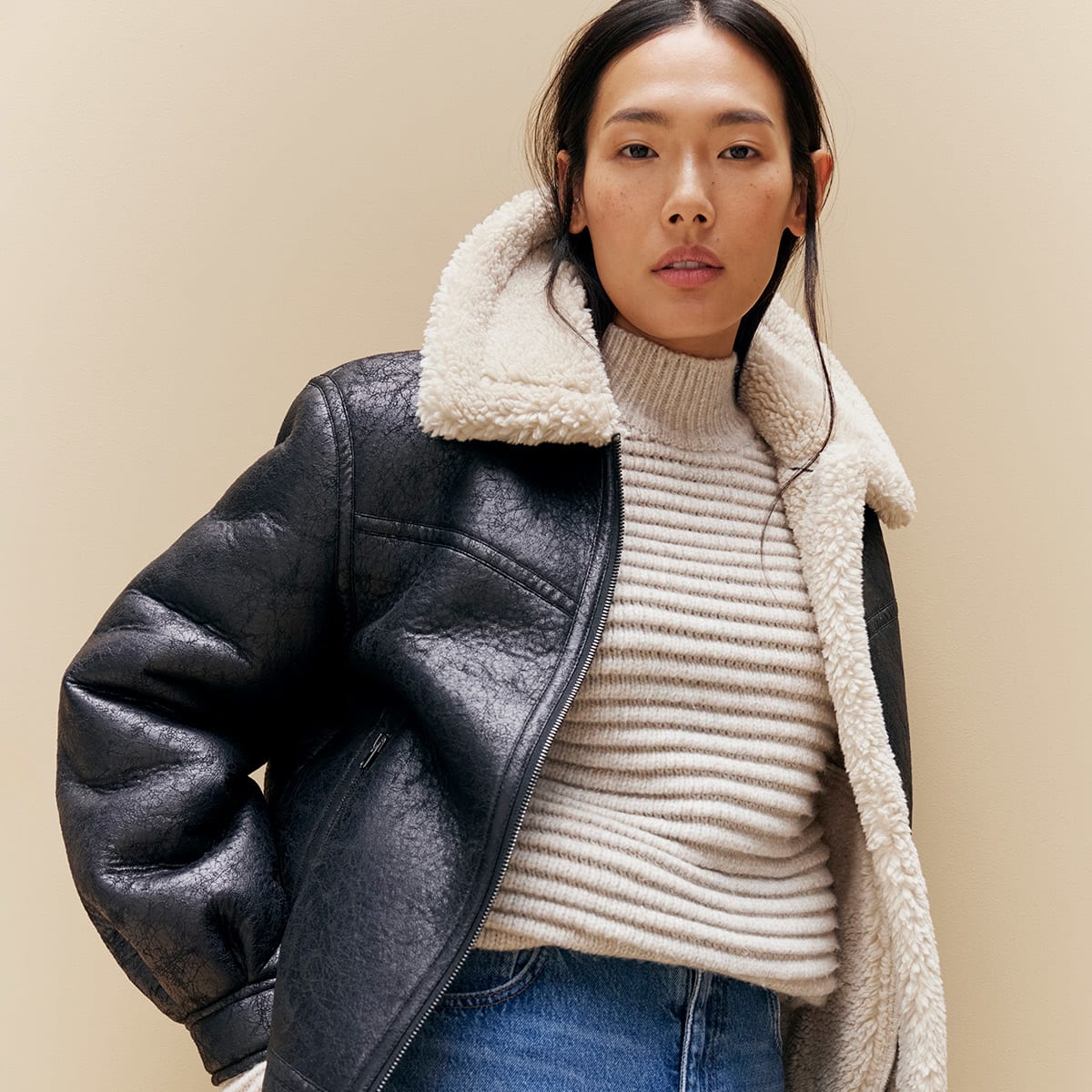  Woman wearing aviator jacket, knit and jeans 