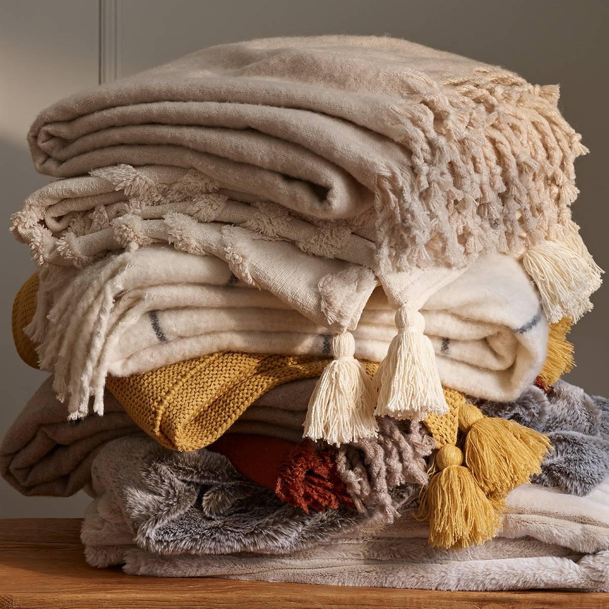 Pile of throws in various colours