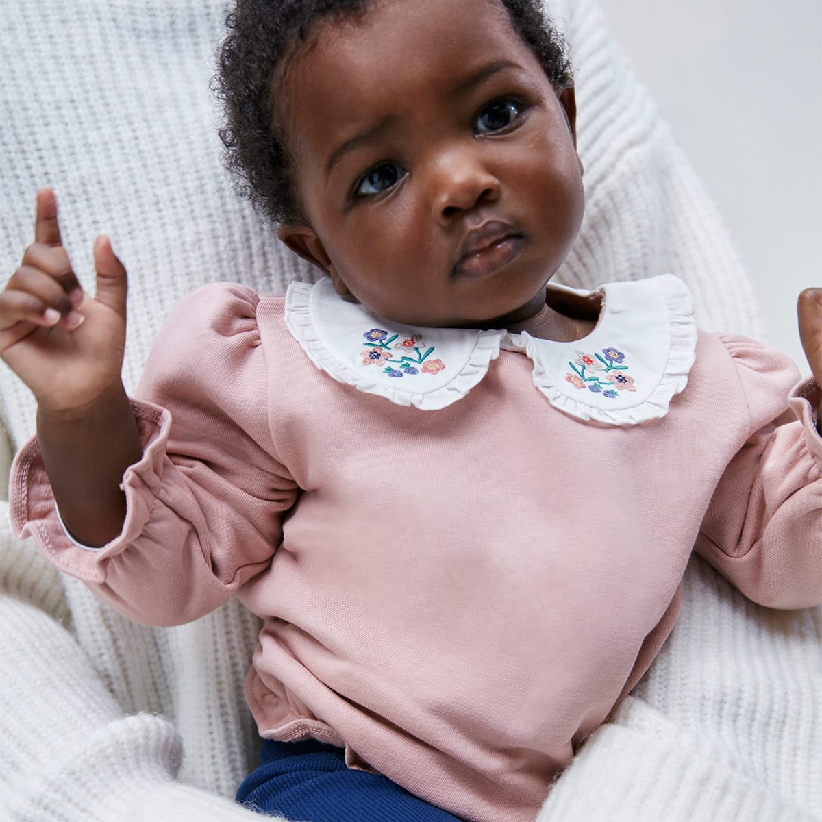  Baby girl wearing pink sweatshirt