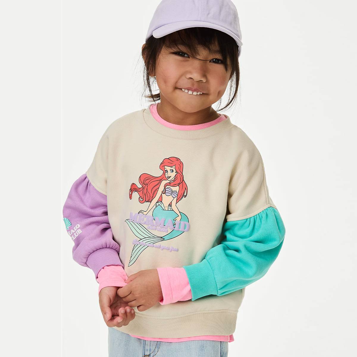 Girl wearing Little Mermaid™ sweatshirt